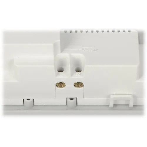 Zbliżenie na biały plastikowy panel z dwoma śrubami oznaczonymi literami "L" i "N". Panel posiada otwory wentylacyjne oraz oznaczenie "6-7 mm".