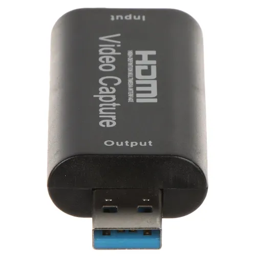 Czarny adapter do przechwytywania wideo z wejściem HDMI i wyjściem USB. Na obudowie widoczne są napisy "HDMI Video Capture", "Input" i "Output".