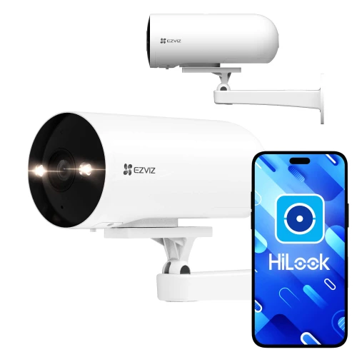 Na zdjęciu znajduje się biała kamera monitoringu Ezviz H5 zamontowana na ścianie oraz smartfon z aplikacją HiLook na ekranie. Kamera ma cylindryczny kształt i jest wyposażona w dwa widoczne reflektory LED.