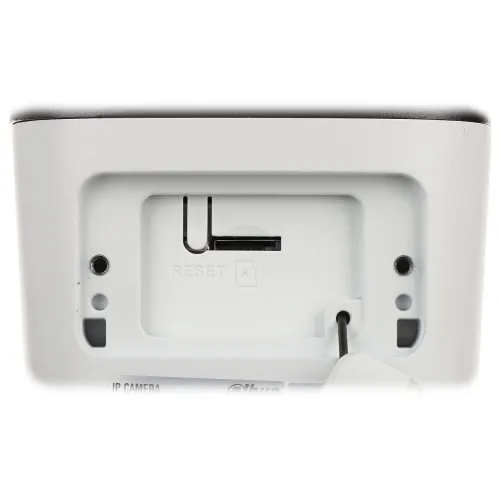 Zdjęcie przedstawia gniazdo karty pamięci oraz przycisk reset na białej obudowie urządzenia. Widać również otwory montażowe i oznaczenia na powierzchni.