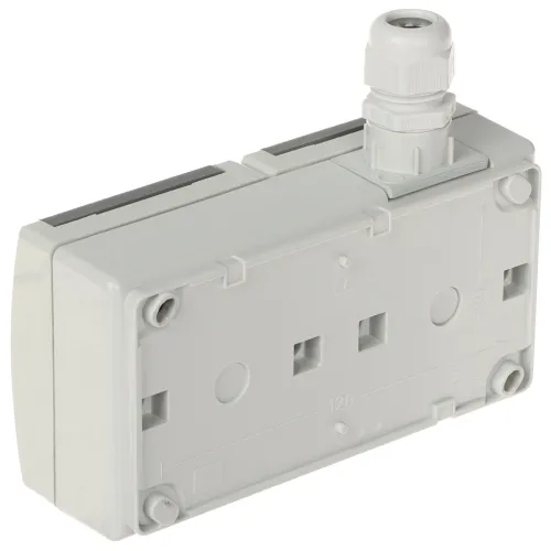 Prostokątna, szara obudowa elektryczna z widocznymi otworami montażowymi i złączem kablowym na górze. Obudowa posiada gładką powierzchnię z oznaczeniami technicznymi i miejscami na śruby.