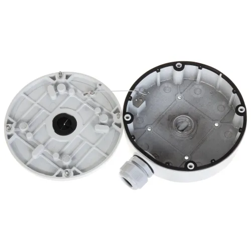 Okrągła, metalowa puszka montażowa do kamer, pokazana w dwóch częściach: pokrywa i podstawa. Widoczne są otwory montażowe oraz przepust kablowy z boku.