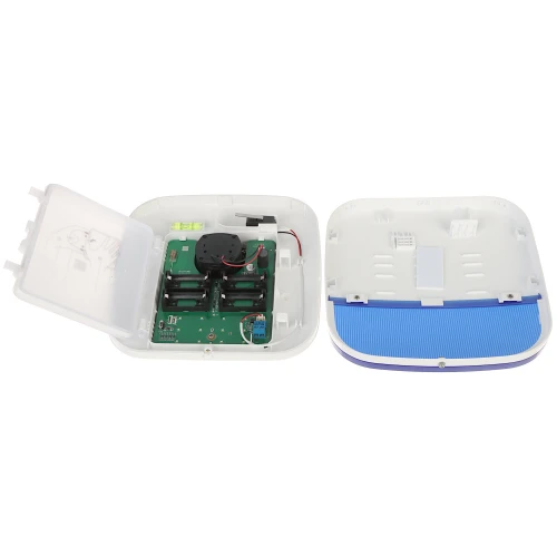 Zdjęcie przedstawia otwartą obudowę alarmu z widocznymi wewnętrznymi komponentami elektronicznymi, takimi jak płytka drukowana i głośnik. Obudowa jest w kolorze białym z niebieskim elementem na dolnej części.