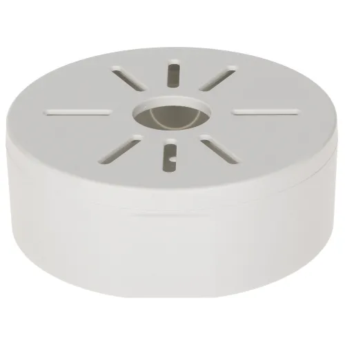 Biała, okrągła puszka montażowa z otworami wentylacyjnymi na górnej powierzchni. Posiada centralny otwór oraz kilka podłużnych szczelin promieniście rozmieszczonych wokół niego.